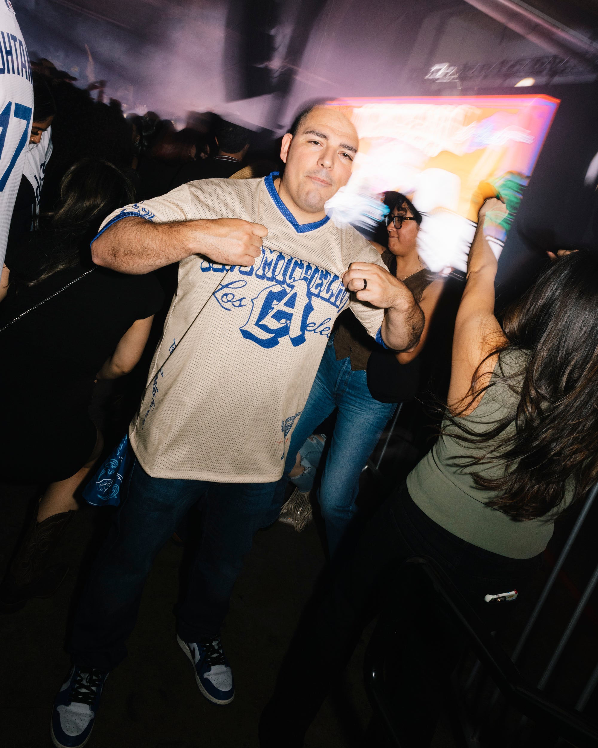 Man in a beige and blue Los Angeles jersey celebrating at I Love Micheladas festival