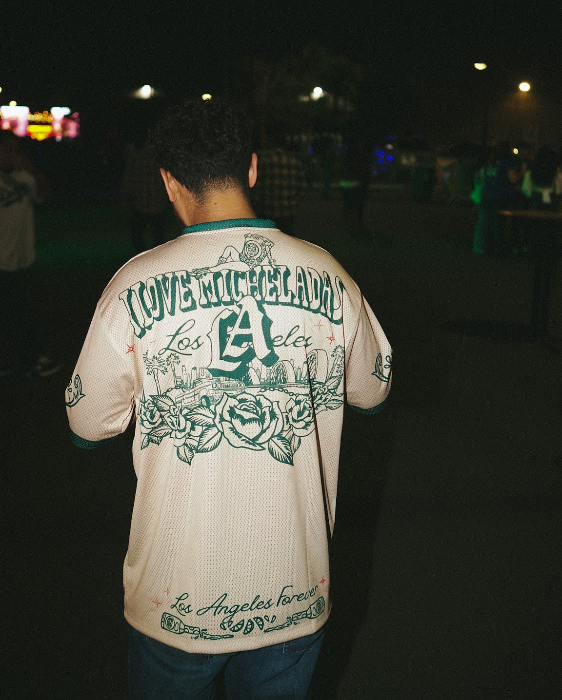 Person wearing a cream with green graphics  Los Angeles jersey at the I Love Micheladas festival