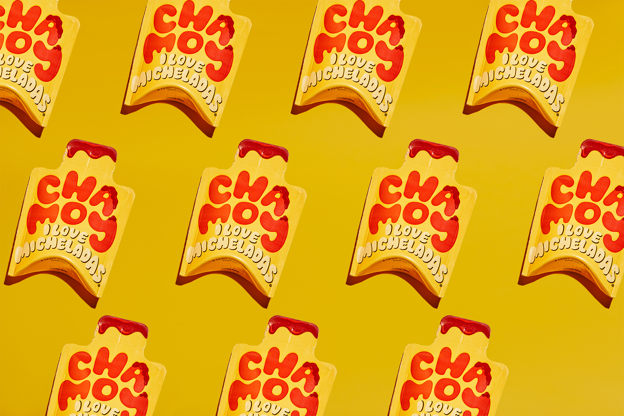 An array of Mini Chamoys packets arranged in a pattern against a yellow background, displaying the brand and product name.